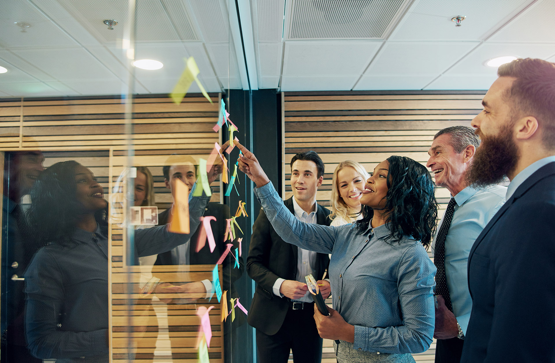 smiling multiethnic staff interacting during office meeting